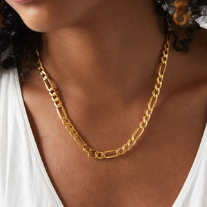 Classic gold plated stainless steel Figaro chain necklace displayed on a model's neck