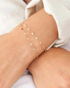 Close-up of a minimalist gold double-layered flat oval link chain bracelet on wrist