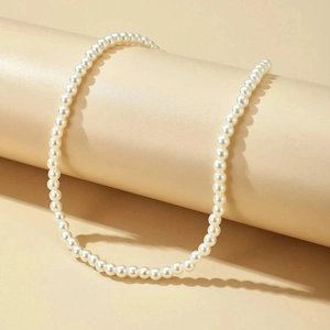 Detail of elegant white imitation pearl necklace with high luster on jewelry cylinder stand