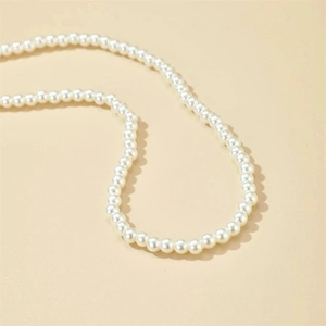 Close-up of 14K gold-plated necklace with elegant cream white pearls and smooth texture