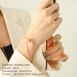 Detailed view of adjustable 14k gold stainless steel snake chain bracelet on a model
