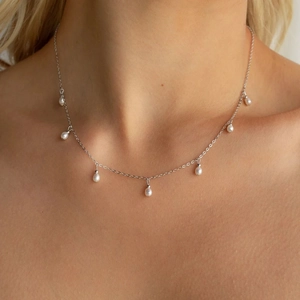 Elegant stainless steel necklace with multiple dangling white pearls on a slim silver chain