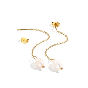 Detailed close-up of gold chain earrings with white oval pearls on white background