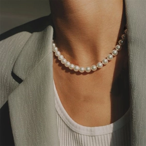 Elegant 14K gold plated pearl necklace worn with a gray suit for a classic look