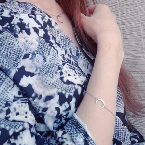Silver crescent moon necklace and bracelet set displayed on a model for style styling