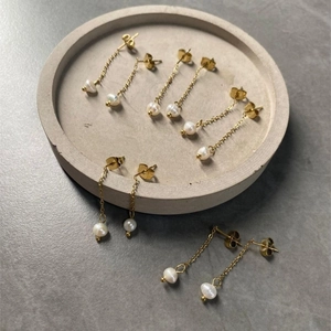 Elegant gold plated stainless steel drop earrings with white pearls in a five-pair set