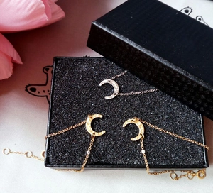 Detail of gold and silver crescent moon bracelets featuring a unique hammered texture