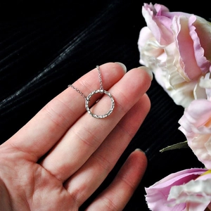 Detailed view of silver minimalist round necklace with handcrafted hammered texture finish