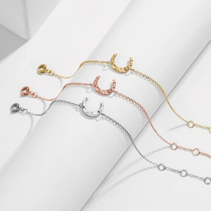 Three minimalist 316L stainless steel crescent moon bracelets in gold silver and rose gold