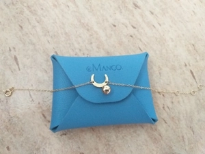 Detail of gold moon pendant bracelet on light blue leather pouch with branded logo