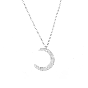 Macro detail of silver crescent moon pendant with hammered texture and delicate chain link