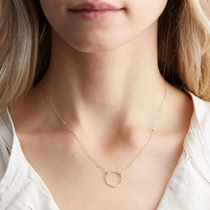 Minimalist gold plated stainless steel necklace with hammered circle pendant on model