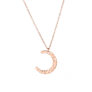 Close-up of crescent moon pendant necklace in rose gold with a unique hammered texture