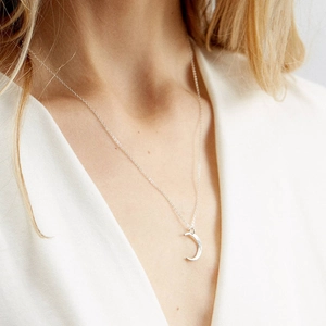 Minimalist hammered crescent moon necklace in silver stainless steel on a model