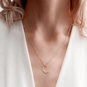 Elegant hammered crescent moon pendant necklace in rose gold finish on female model