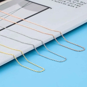 Close-up of thin adjustable cable chains in gold, silver, and rose gold finishes
