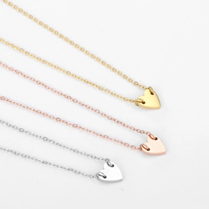 Three minimalist heart pendant necklaces in gold, silver, and rose gold finishes
