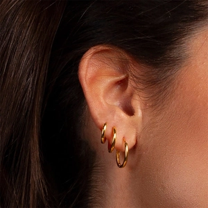 Three-piece set of gold geometric hoop earrings shown on model for a minimalist daily look