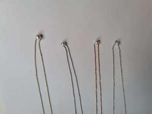 Detailansicht der Perlenketten in Gold, Silber und Roségold nebeneinander präsentiert