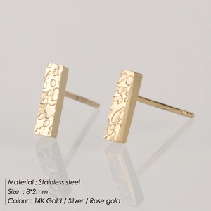 Macro view of geometric bar earrings with textured hammered finish in gold stainless steel