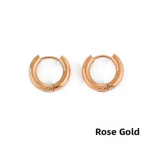 Detailed close-up of polished rose gold stainless steel hoop earrings with snap closure
