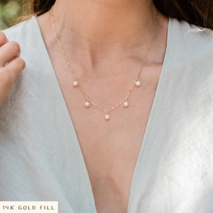 Detailed view of a 14K Gold Filled necklace featuring delicate white pearl pendants