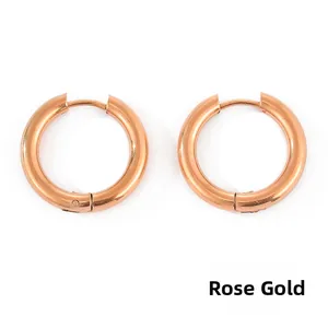 Detail of rose gold stainless steel hoop earrings with secure snap closure and polished finish