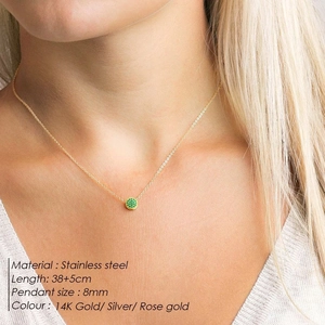 Detailed close-up of 8mm green zircon pendant on 14K gold stainless steel chain
