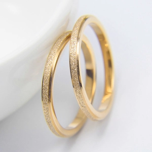 Detailed macro shot of gold titanium steel rings with matte finish and polished edges