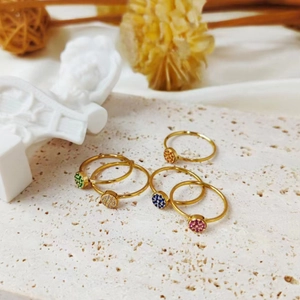 Detail of five-piece gold titanium steel ring set with colorful birthstone zircons