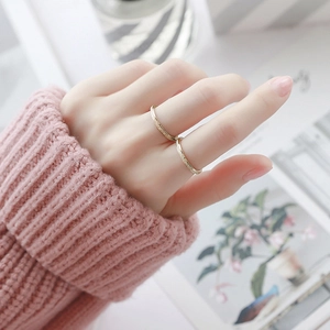 Set of two gold stainless steel rings with minimalist band and shimmering pavé stone detail