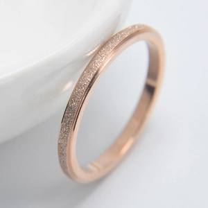 Macro shot of rose gold titanium ring featuring a frosted finish and polished edges