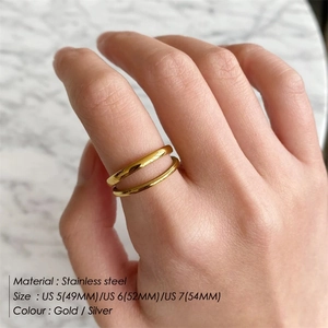 Double layer stainless steel open ring for women shown on a model hand with marble background