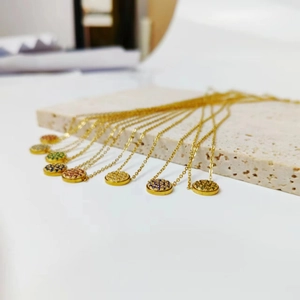 Detailed close-up of gold-plated birthstone necklaces with micro-pave colored crystals
