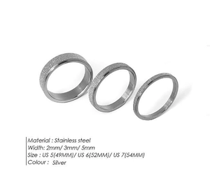 Close-up of 2mm, 3mm and 5mm silver stainless steel rings with frosted sand texture