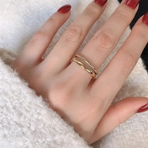 Double-layered gold stainless steel ring worn on finger with modern minimalist style