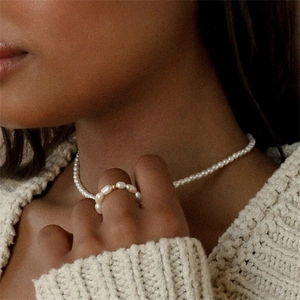 Baroque freshwater pearl necklace and ring set with gold bead on a cozy knit model