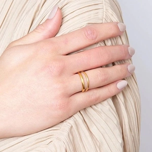 Minimalist double layer gold stainless steel ring with polished finish on model hand