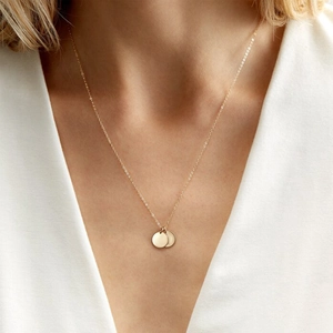Elegant gold stainless steel necklace with double flat disc pendants on a fine chain