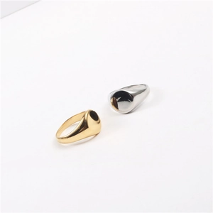 Detailed view of minimalist polished round signet rings in gold and silver finish
