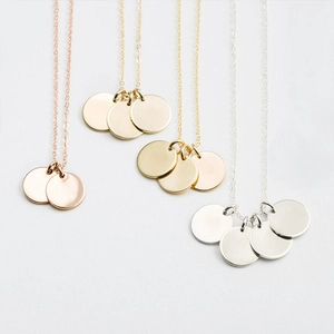 Stainless steel necklace set with round disc pendants in gold, silver, and rose gold finishes