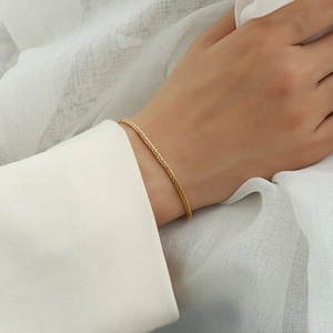 Macro detail of elegant gold plated popcorn chain bracelet on a model wrist