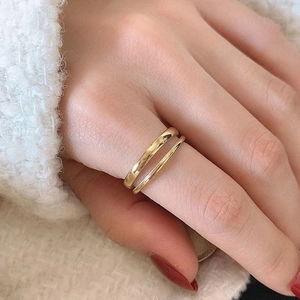 Minimalist double layer gold stainless steel rings with a polished finish worn on hand