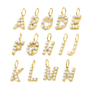 Macro view of gold-plated alphabet letter pendants A-N with white faux pearl inlays