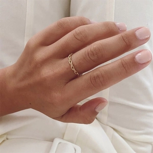 Detailed view of a gold-plated oval link chain ring worn on a finger for daily styling