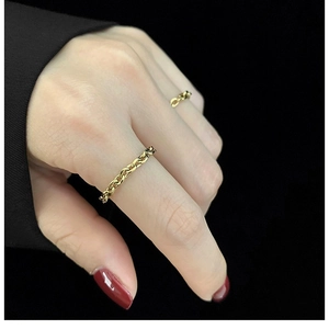 Minimalist gold plated stainless steel chain ring for women shown on a model hand