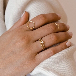 Detailed view of 4-piece gold stainless steel ring set with star and crystal details