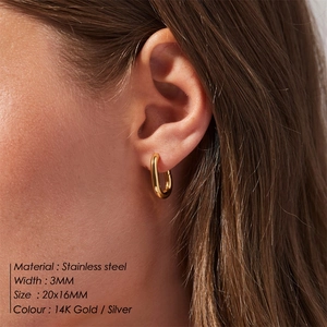 Minimalist 14K gold plated stainless steel U-shaped hoop earrings worn by a model