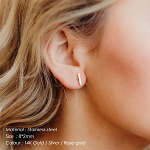 Minimalist stainless steel bar studs 8x2mm in gold, silver, and rose gold on model