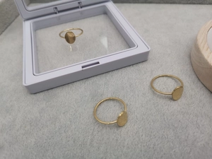 Three minimalist gold-plated oval rings on display with matte stainless steel finish